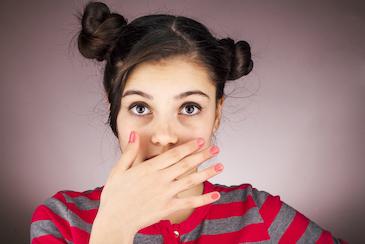 Young girl covering her mouth with clear aligners, Roseville NSW