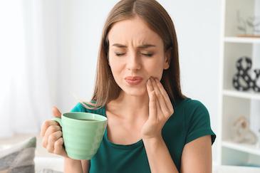 Woman holding her mouth in pain, in need of a root canal treatment, Roseville NSW