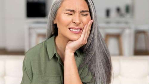 Woman experiencing severe tooth pain, a common reason to seek Emergency Dentistry in Roseville.