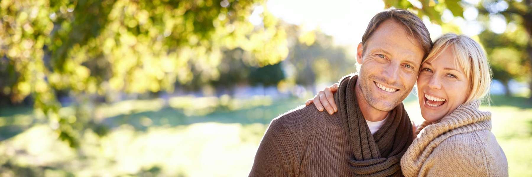 Man and woman smiling after dental implants, Roseville NSW