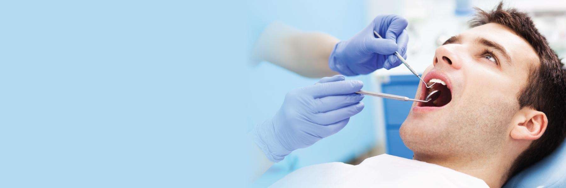 Man in dentist chair getting root canal treatment, Roseville NSW