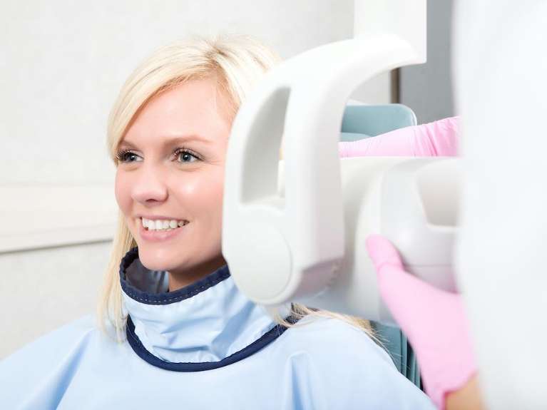 Blonde woman sitting in dentist chair about to get a digital x-ray, Roseville NSW